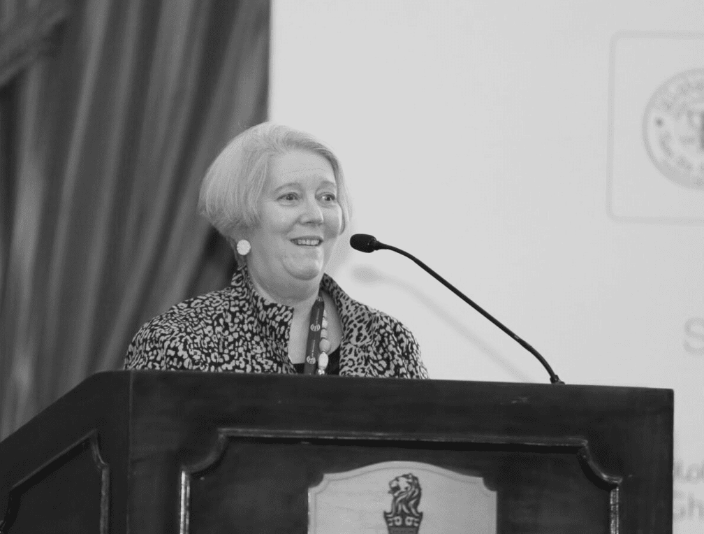 Mary Kay Kane presenting at a podium.
